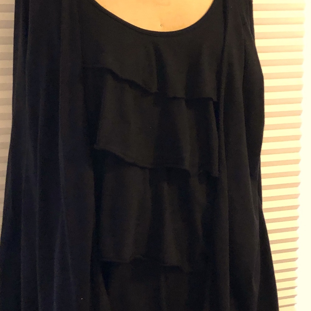 1 piece ruffled top gives the illusion of 2 pc.Ruffled only in front Long sleeve